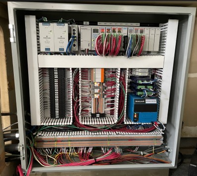 Inside of a control panel showing wires and components.